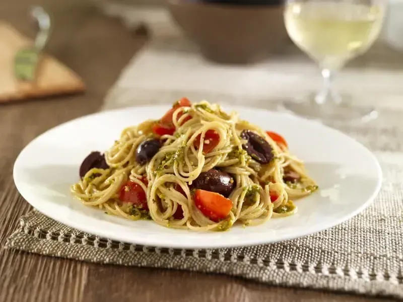 Barilla® Whole Grain Thin Spaghetti with Pistachio & Basil Pesto, Cherry Tomatoes and Black Olives Recipe | US_PROD-a31899dd-d78c-423b-8fdd-667c2d571eee