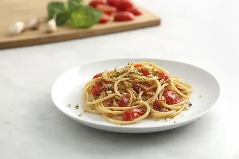 Barilla® Bucatini Pasta with Pancetta, Grape Tomatoes, and Pesto Flavored Crispy Panko Recipe | US_PROD-23b1f425-edc3-439a-ab5b-c5150e0d1e4f