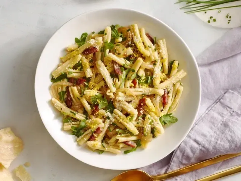 Barilla® Casarecce Pasta with Pancetta, Grated Egg Yolk, Arugula and Chives Recipe | US_PROD-5e39d6a9-9587-4422-a4d6-bc8743fc4543