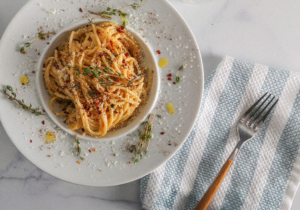 Barilla® Al Bronzo® Spaghetti Creamy Cacio e Pepe Pasta with Chili Flakes and Fresh Thyme Recipe | US_PROD-70fRkauiIwr5AiQzAFENeh