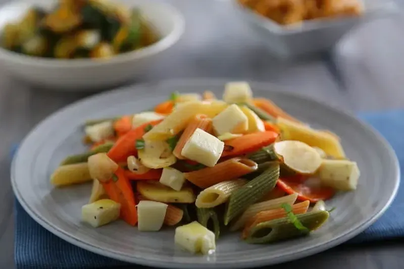 Barilla® Tri-Color Penne Pasta Salad with Roasted Carrots, Parsnips, Onions, Fresh Mozzarella and Basil Recipe | US_PROD-a2501a30-542d-4e3e-bd1a-00fbc2644e20