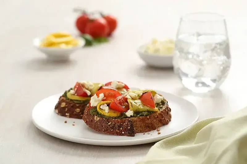 Barilla® Rustic Basil Pesto Crostini with Yellow Squash, Cherry Tomato and Feta Cheese Recipe | US_PROD-07be2f1a-2da0-4c40-a8a2-54b62b4ea292