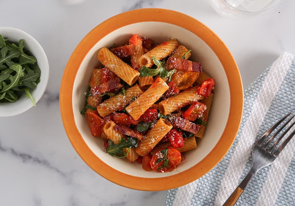 Barilla® Protein+® Rigatoni Pasta with Arugula, Cherry Tomatoes, Cheese and Bacon Recipe | US_PROD-4aIsNuLeH7xFYr7Nh8TSM8